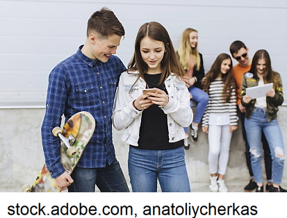 some teenagers in front of a wall